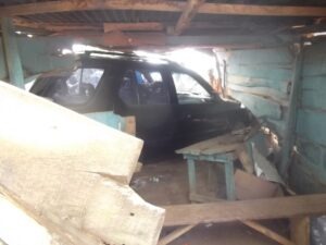 The Isuzu SUV still inside the shop after the accident
