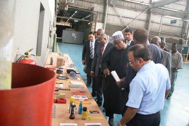 The entire delegation admiring select locally sourced materials used in vehicle assembly.